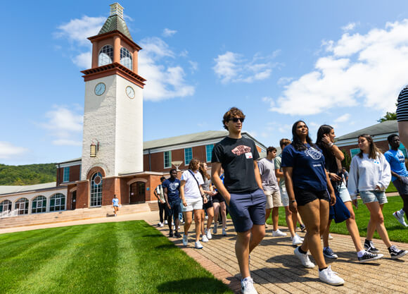 A group of new international students walks across the quad during Orientation